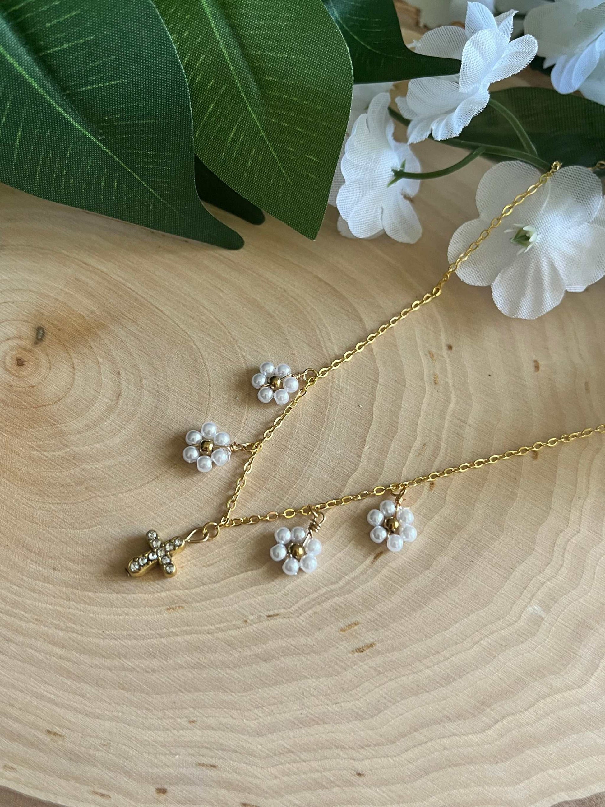 Gold Necklace with 16K gold pendant featuring daisies and a cross.
