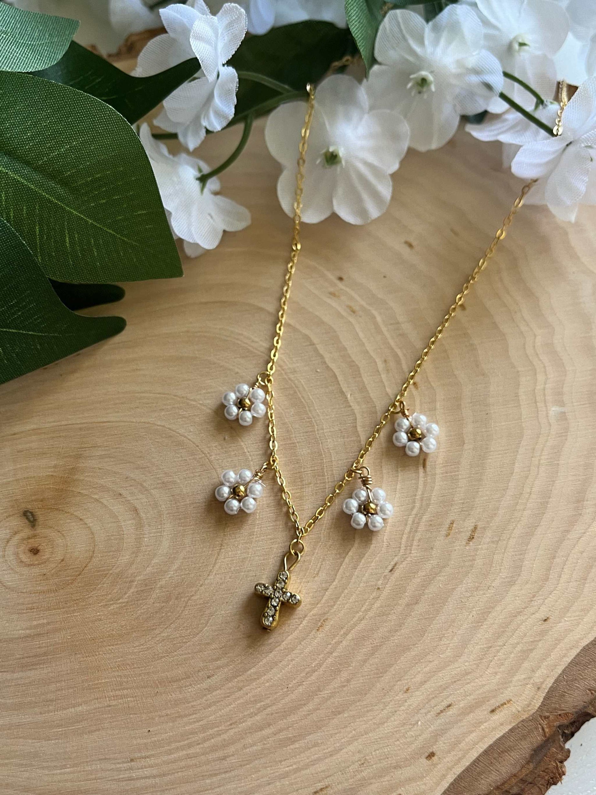 Gold Necklace with 16K gold pendant featuring daisies and a cross.
