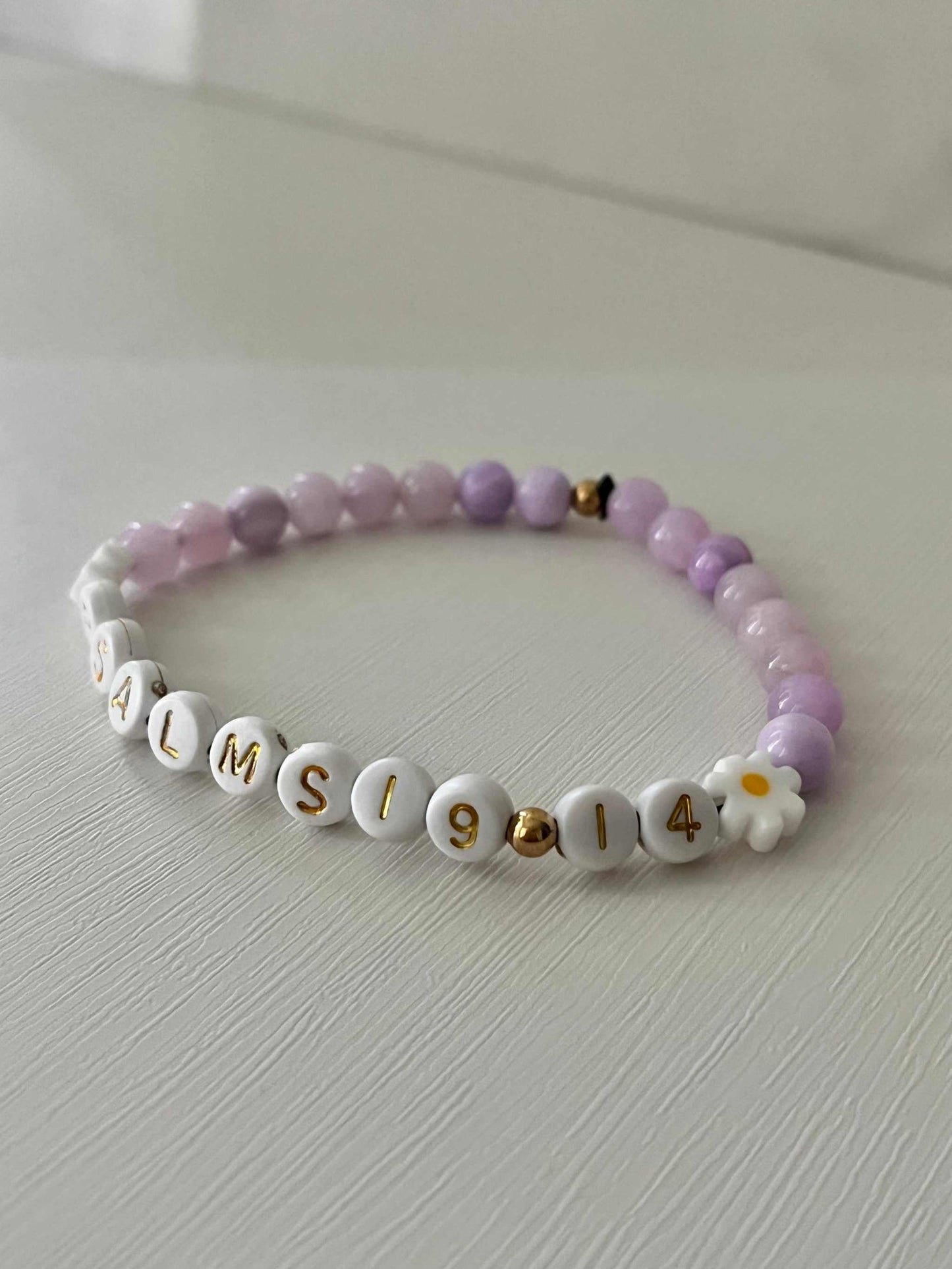 Lavender Daisy Rhodonite Bracelet showcasing white daisies and lavender rhodonite beads, ideal for expressing faith and style.