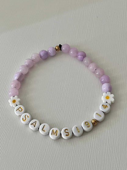 Lavender Daisy Rhodonite Bracelet showcasing white daisies and lavender rhodonite beads, ideal for expressing faith and style.