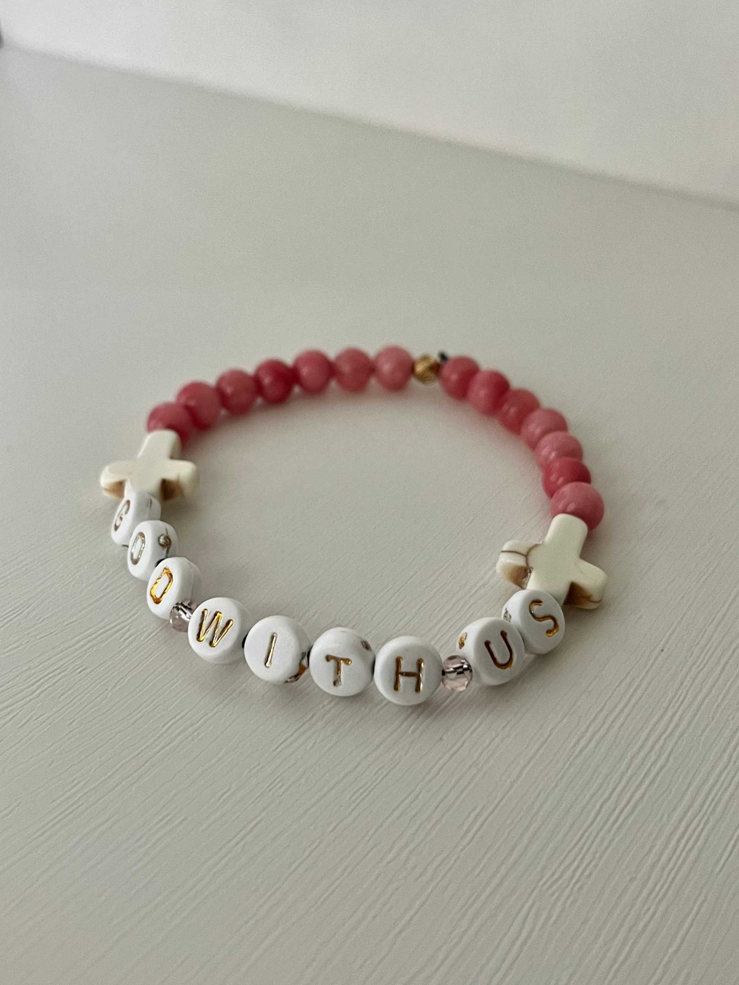 GOD WITH US pink marble beads bracelet, haPink Marble God With Us Bracelet showcasing elegant pink marble beads and a charm, ideal for adding a touch of faith-inspired style to your collection.ndmade bracelet, womens bracelet, bracelet for women, stretch bracelet, stone bracelet