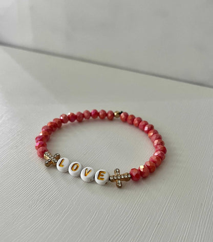 Love Red Glass Bead Bracelet with gold crosses – elegant faith-inspired jewelry.

