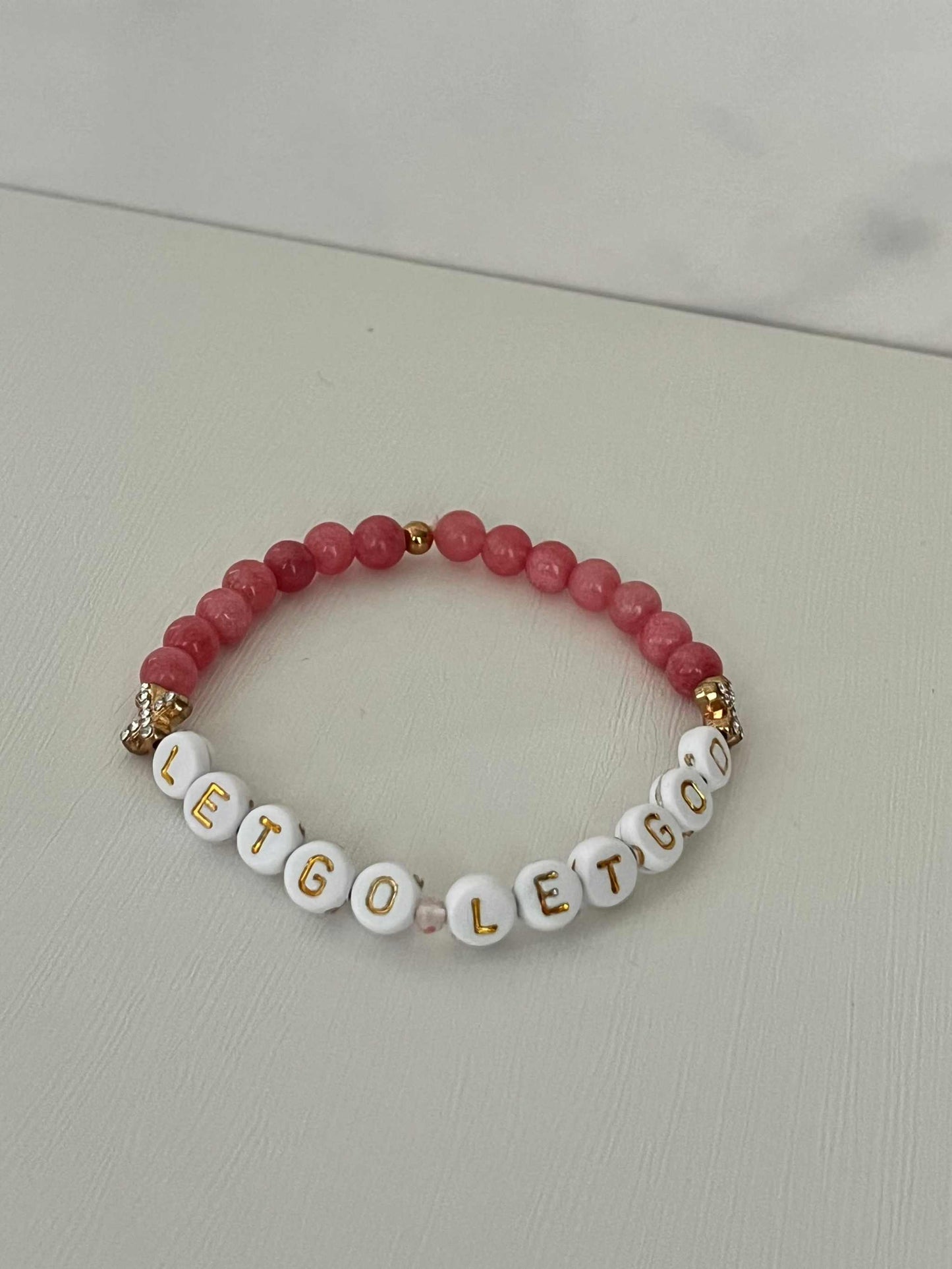 Let Go Let God Bracelet with pink glass marbled beads and gold crosses