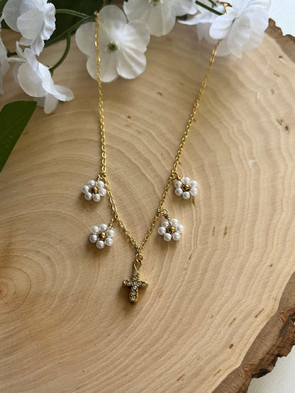 Gold Necklace with 16K gold pendant featuring daisies and a cross.
