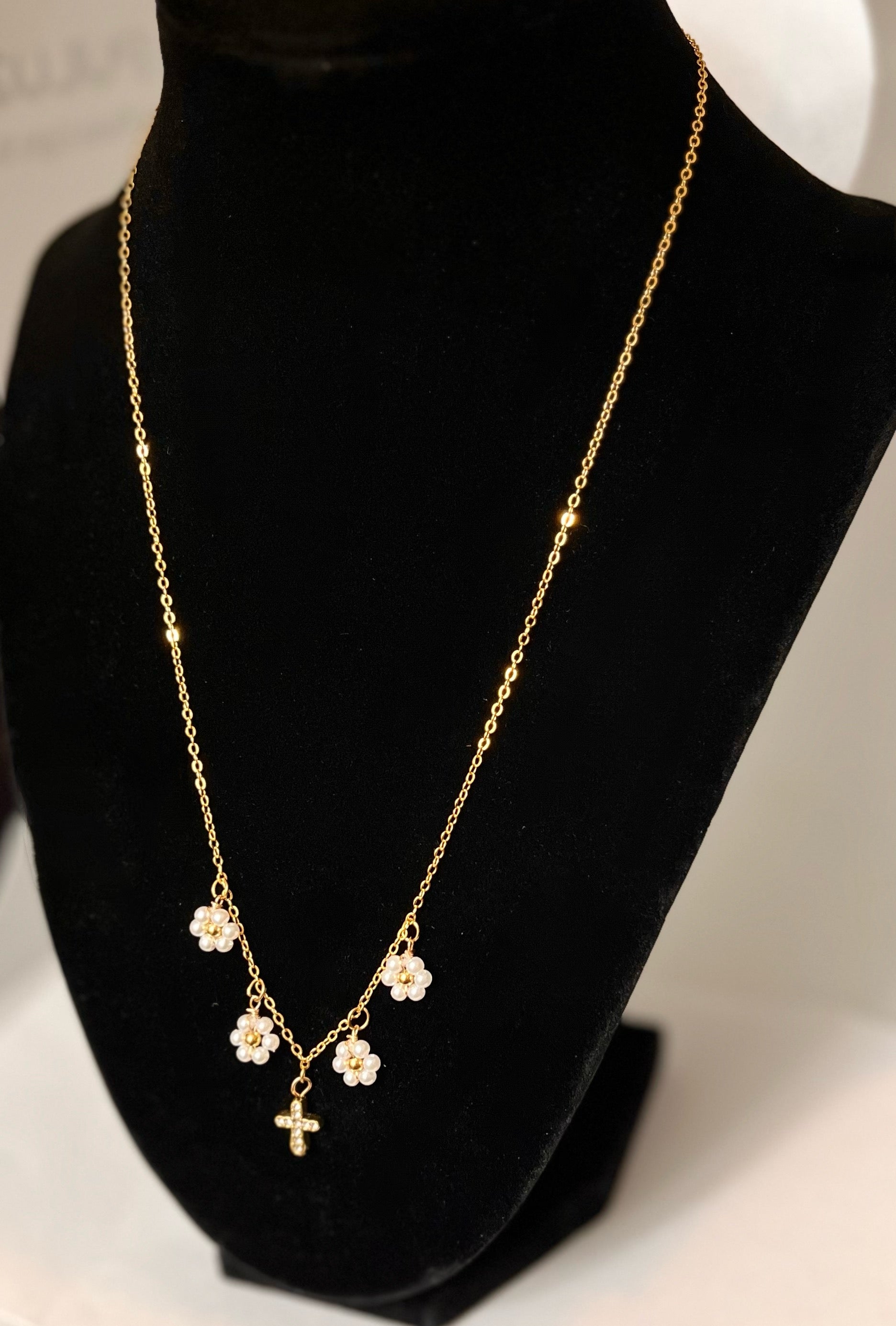 Gold Necklace with 16K gold pendant featuring daisies and a cross.

