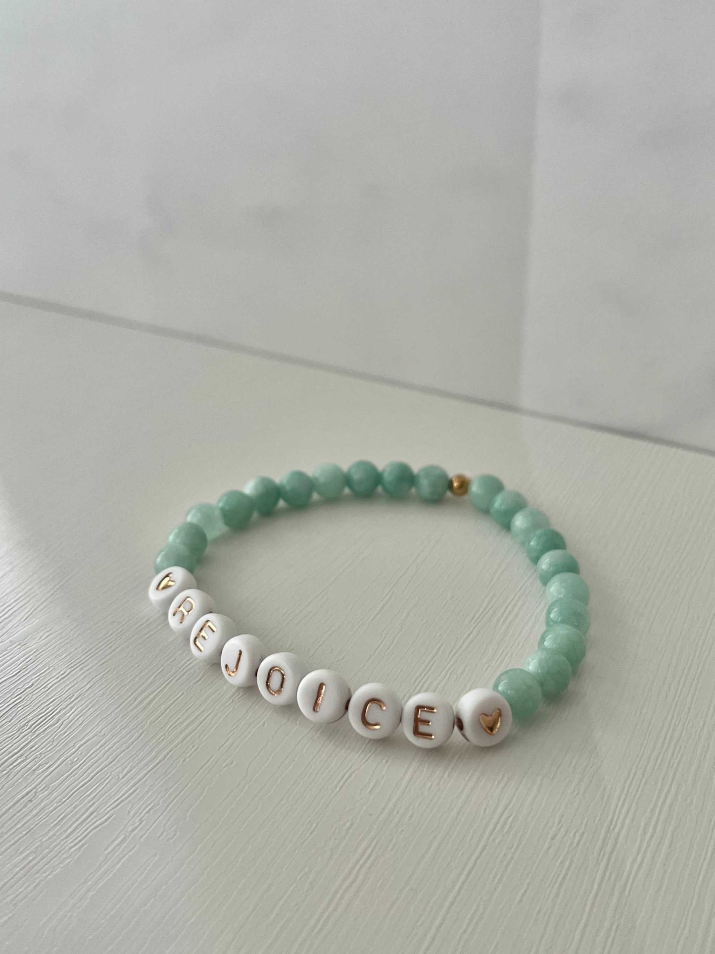 Rejoice Green Jade Bracelet showcasing beautiful green jade stones, ideal for expressing faith and adding a touch of elegance to your jewelry collection.