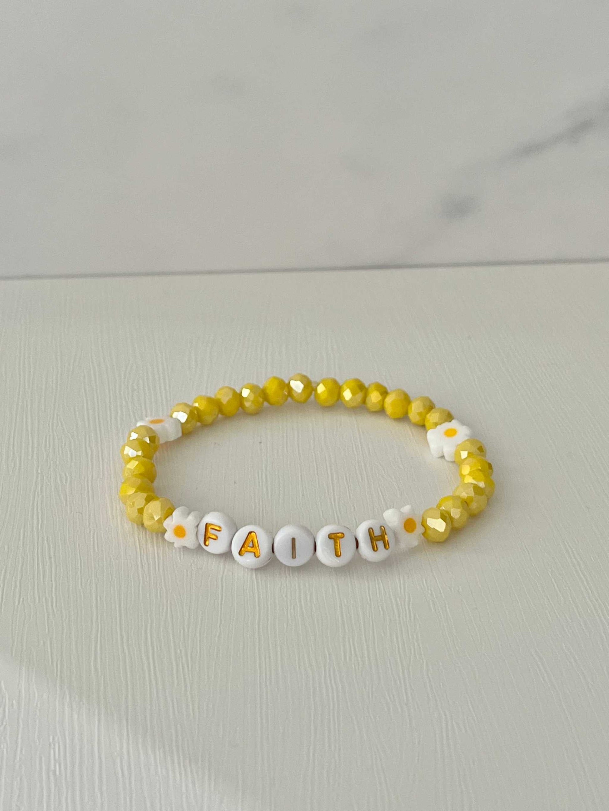 Yellow glass faceteYellow Faceted Faith Healing Bracelet showcasing vibrant yellow beads, perfect for adding a touch of healing and faith-inspired style to your jewelry collection.d Faith bracelet with daisies