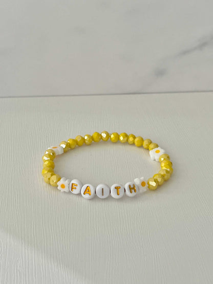 Yellow glass faceteYellow Faceted Faith Healing Bracelet showcasing vibrant yellow beads, perfect for adding a touch of healing and faith-inspired style to your jewelry collection.d Faith bracelet with daisies