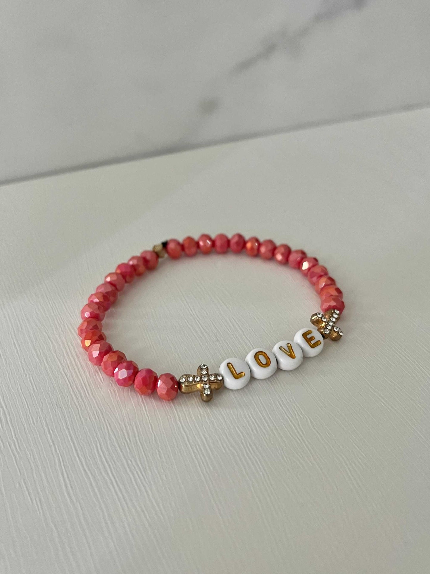 Love Red Glass Bead Bracelet with gold crosses – elegant faith-inspired jewelry.

