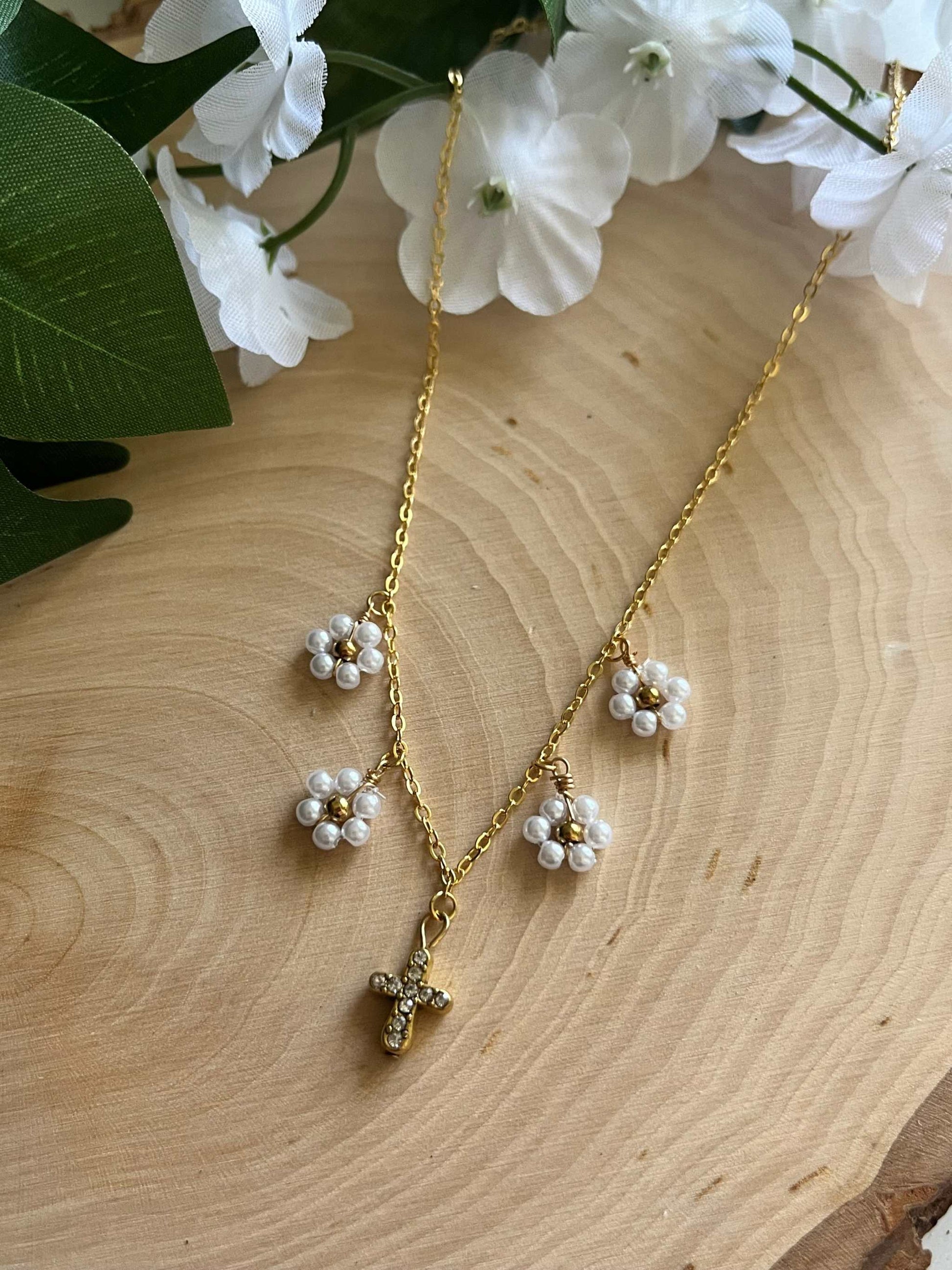 Gold Necklace with 16K gold pendant featuring daisies and a cross.
