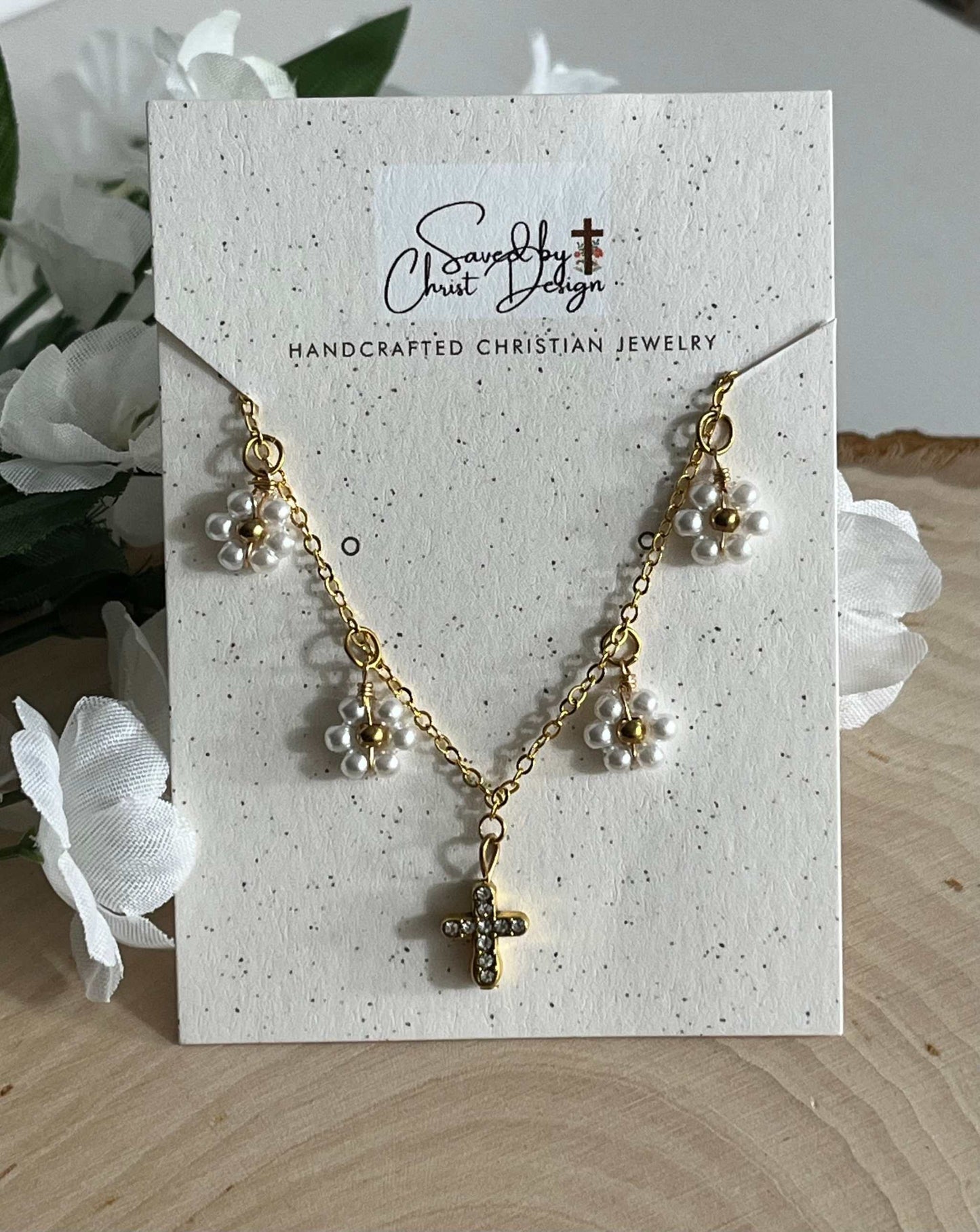 Gold Necklace with 16K gold pendant featuring daisies and a cross.