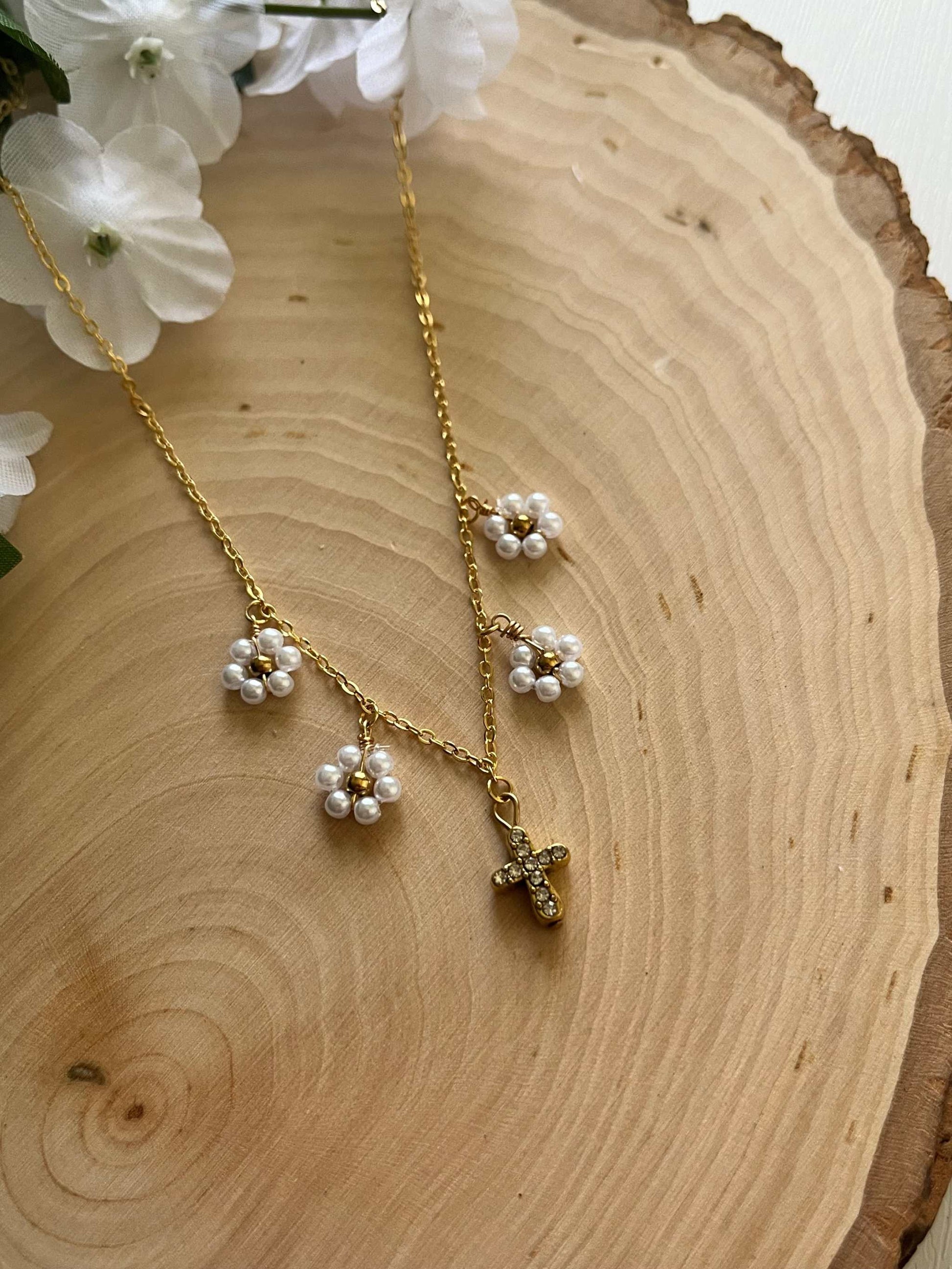 Gold Necklace with 16K gold pendant featuring daisies and a cross.
